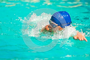 The man quickly swims in the pool