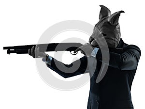 Man with rabbit mask hunting with shotgun silhouette portrait