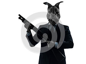 Man with rabbit mask hunting with shotgun silhouette portrait