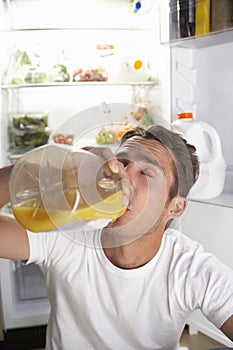 Man Raiding The Fridge For Drink At Night