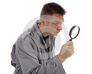 Man with raincoat is looking with magnifying glass over white ba