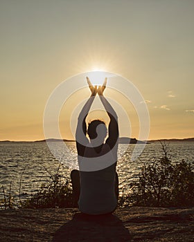 Man with raised hands catching the setting sun. Corona times appreciation of life.