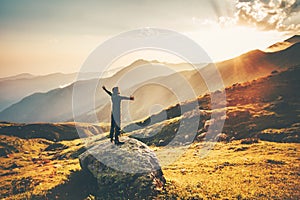 Man raised hands at sunset mountains