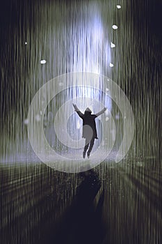 Man raising arms in the rain at night photo