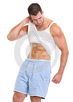 Man raising shirt to show abdominal muscles