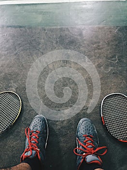 A man with the raket after playing badminton