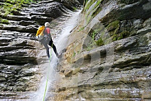 A man rappeling in Pyrenees, Spain.