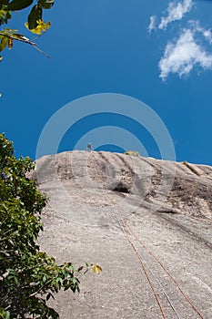 Man Rappelling from Cliff