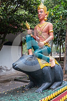 Man on rat statue at Wang Saen Suk monastery, Bang Saen, Thailand