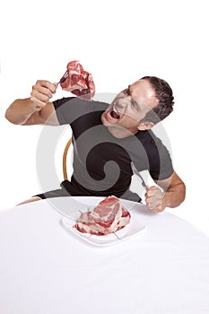 Man with raw steak eating
