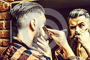 Man with razor near mirror