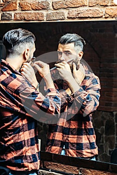 Man with razor near mirror