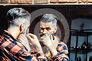 Man with razor near mirror