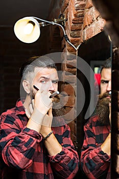 Man with razor near mirror