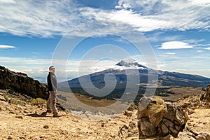 Man reached the top of the mountain.hiker observes the orizonte in the chasm of the Iztaccihuatl volcano Popocatepetl National