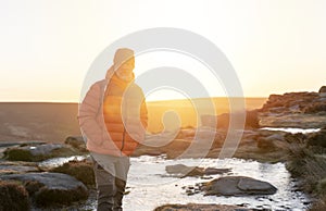 Man reaching the destination and on the top of mountain at sunrise or sunset on cold day Travel Lifestyle concept The