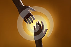 Man reaching for woman`s hand on color background. Help and support concept