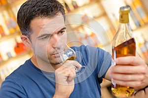 Man reading alcohol label