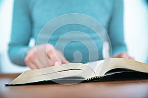 Man reading Bible on the table