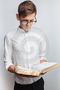 Man reading Bible, white background, book in hand close-up