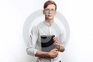 Man reading Bible, white background, book in hand close-up