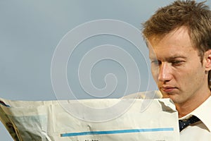 Man reading a blank newspaper