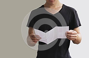 Man reading blank white flyer brochure booklet. Leaflet presentation. Pamphlet hold hands. Man show clear offset paper. Sheet temp