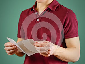Man reading blank white flyer brochure. Read detailed booklet. L