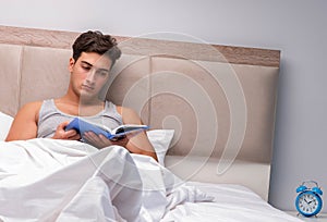 Man reading book in the bed