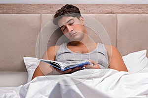 The man reading book in the bed