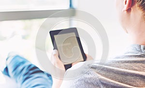 Man reading a book on digital device