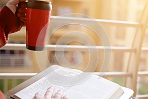 Man is reading book with holding water bottle in hand