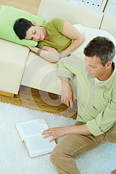 Man reading book at home