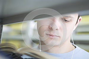 Man Reading Book While Listening Music