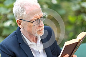 Man reading a book outdoors