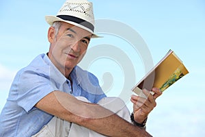 Man reading a book outside