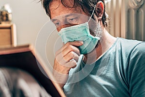 Man reading book in self-isolation quarantine at home