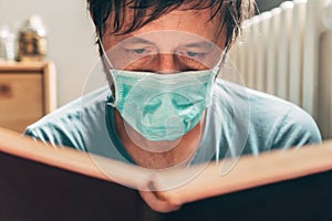 Man reading book in self-isolation quarantine at home