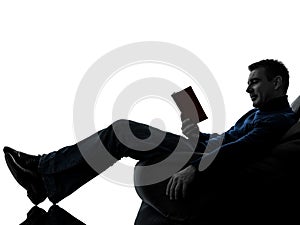 Man reading book silhouette full length