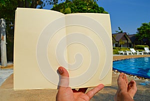 Man is reading a book on vacation