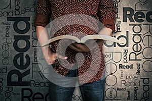 Man reading a book and the word Read on the background photo