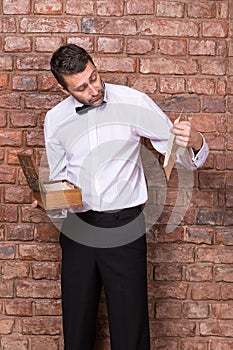 Man reading a document from a wooden box