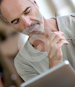 Man reading ebook on digital tablet