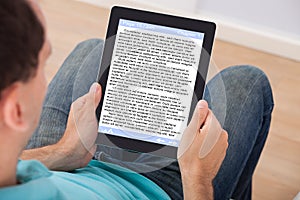 Man reading ebook at home