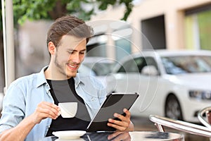 Man reading an ebook or tablet in a coffee shop