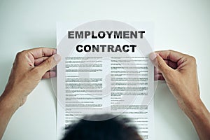 Man reading an employment contract