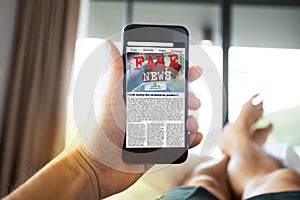 Man reading fake news or articles about covid-19 in a smartphone screen application