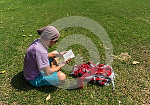 Man is reading his notes outdoor
