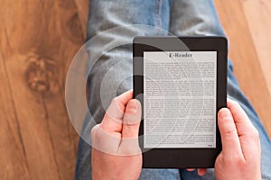 Man reading and holding e-book on digital tablet device