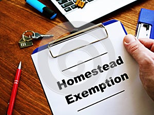 Man is reading Homestead Exemption at the home photo